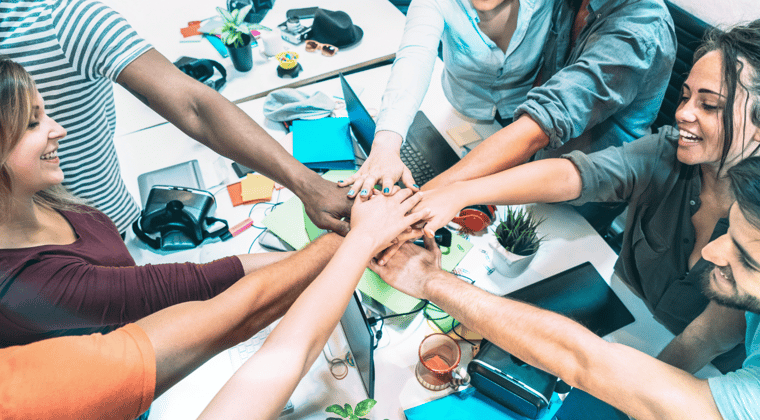 employee morale and culture - coworkers joining hands